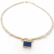 Gold bracelet with a blue square stone on a white background