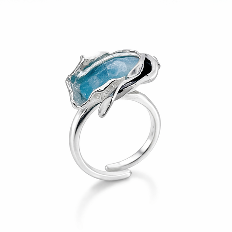 Silver ring with a blue stone on a white background