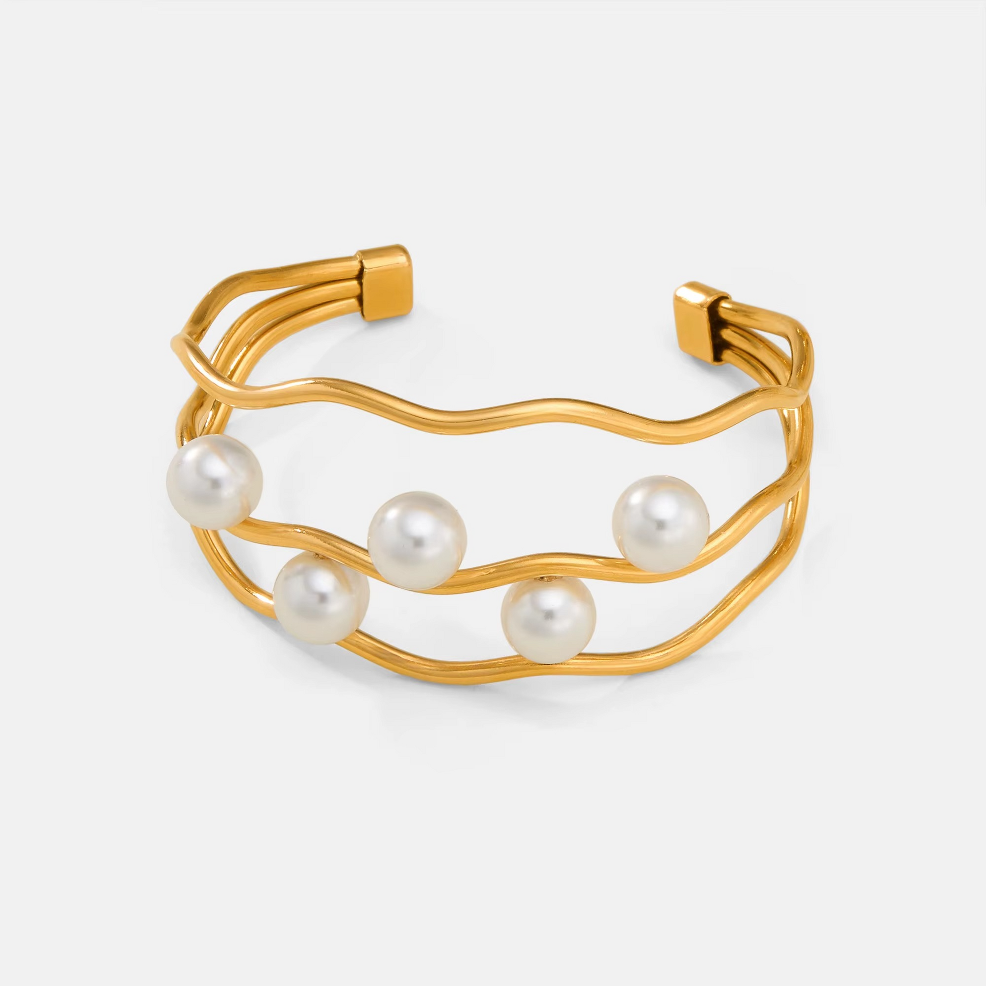 Gold plated stainless steel cuff bracelet with pearl accents

