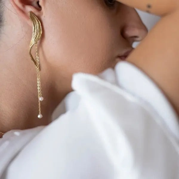 Bronze sculptural drop earrings with pearl details, worn on model, handmade in Greece