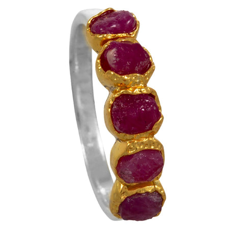Ring with gold and silver band and red gemstones on a white background